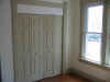 Blair St downstairs front bedroom with new closet doors.JPG (69454 bytes)